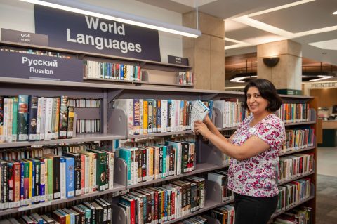 Staff shelving books in the world languages section Staff shelving books in the world languages section
