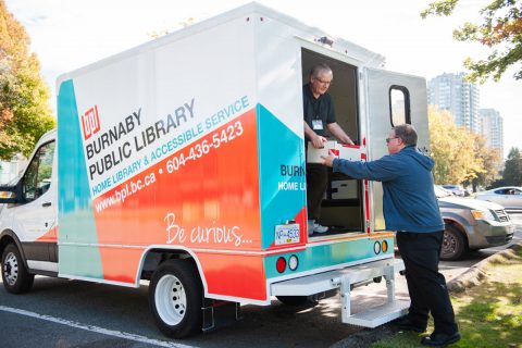 Staff unloading books from the Home Library and Accessible Service truck Staff unloading books from the Home Library and Accessible Service truck